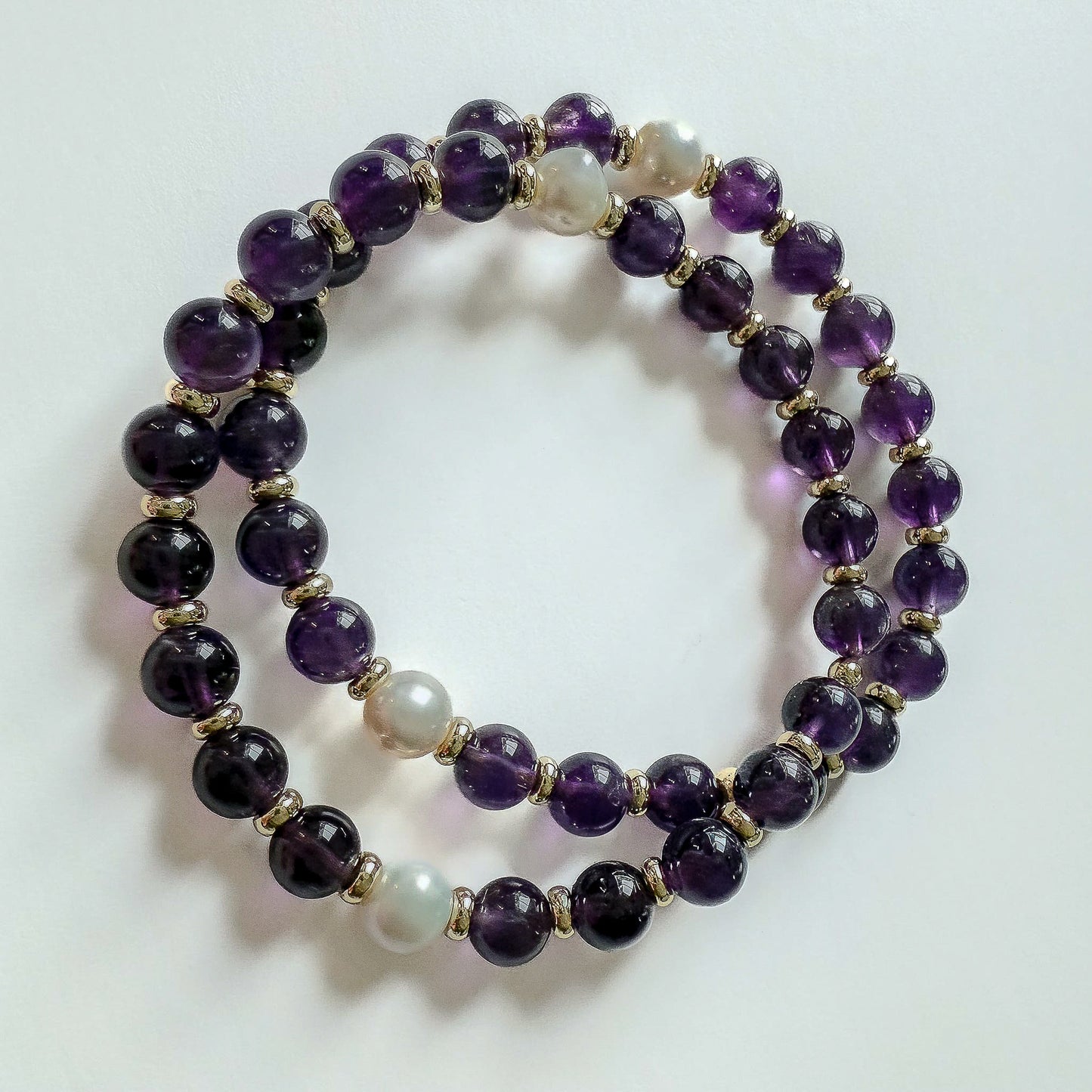 Bracelet set of 2- handcrafted ameth yet and gold beaded bracelets with white freshwater pearls. Handcrafted in Atlanta Georgia by Hope and Raye.