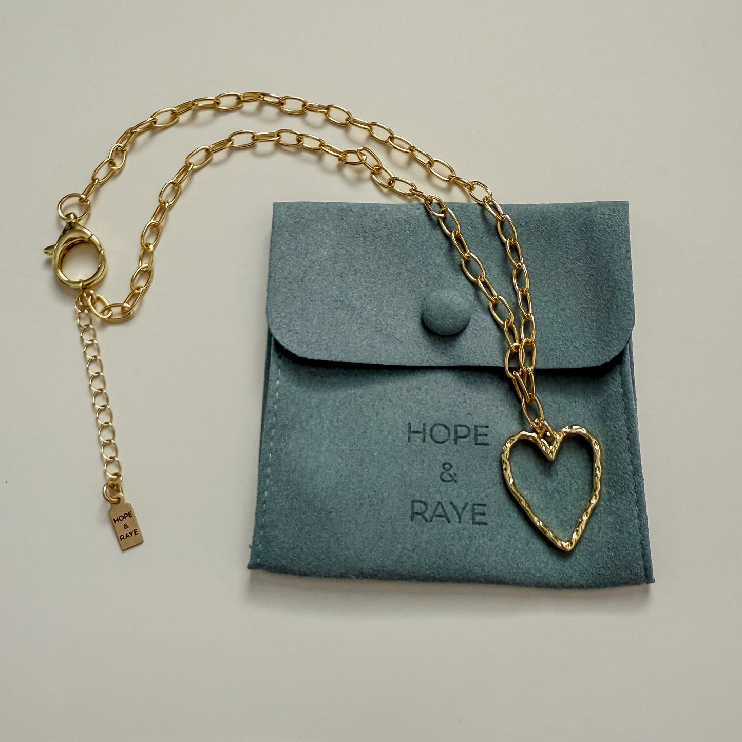 Gold hammered heart charm necklace by Hope and Raye