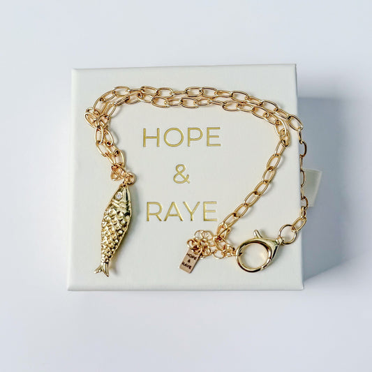 Minimalist gold charm necklace with Fish charm by Hope and Raye. Ships gift-ready in branded pull-out jewelry box and velvet pouch for safe keeping.