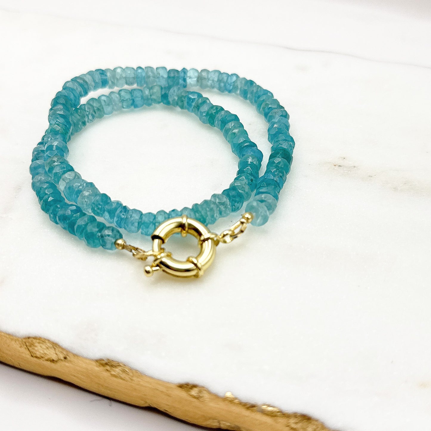 Faceted apatite be at Jim Stone 16 inch necklace handcrafted with 18k gold clasp. Inspired by the waters of Bora Bora.