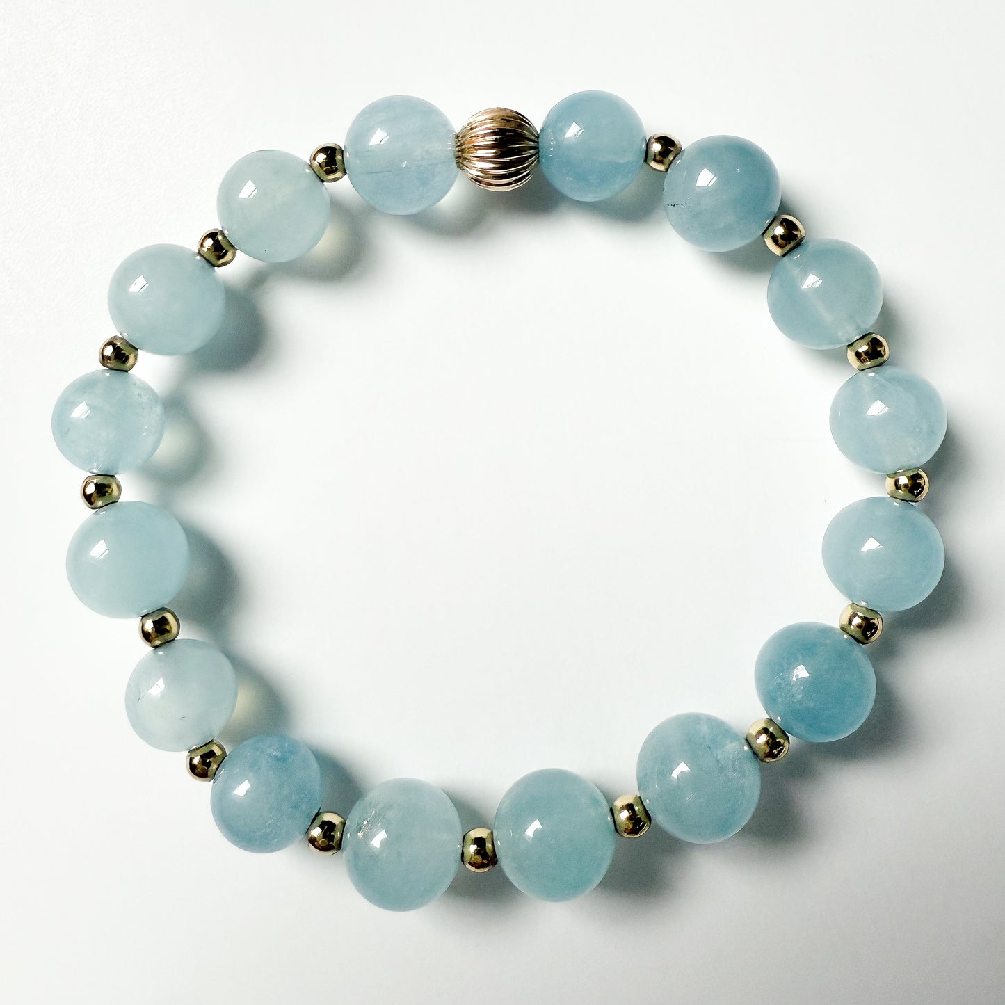 Aquamarine 7 mm beaded stretch bracelet with gold beads by Hope and Raye