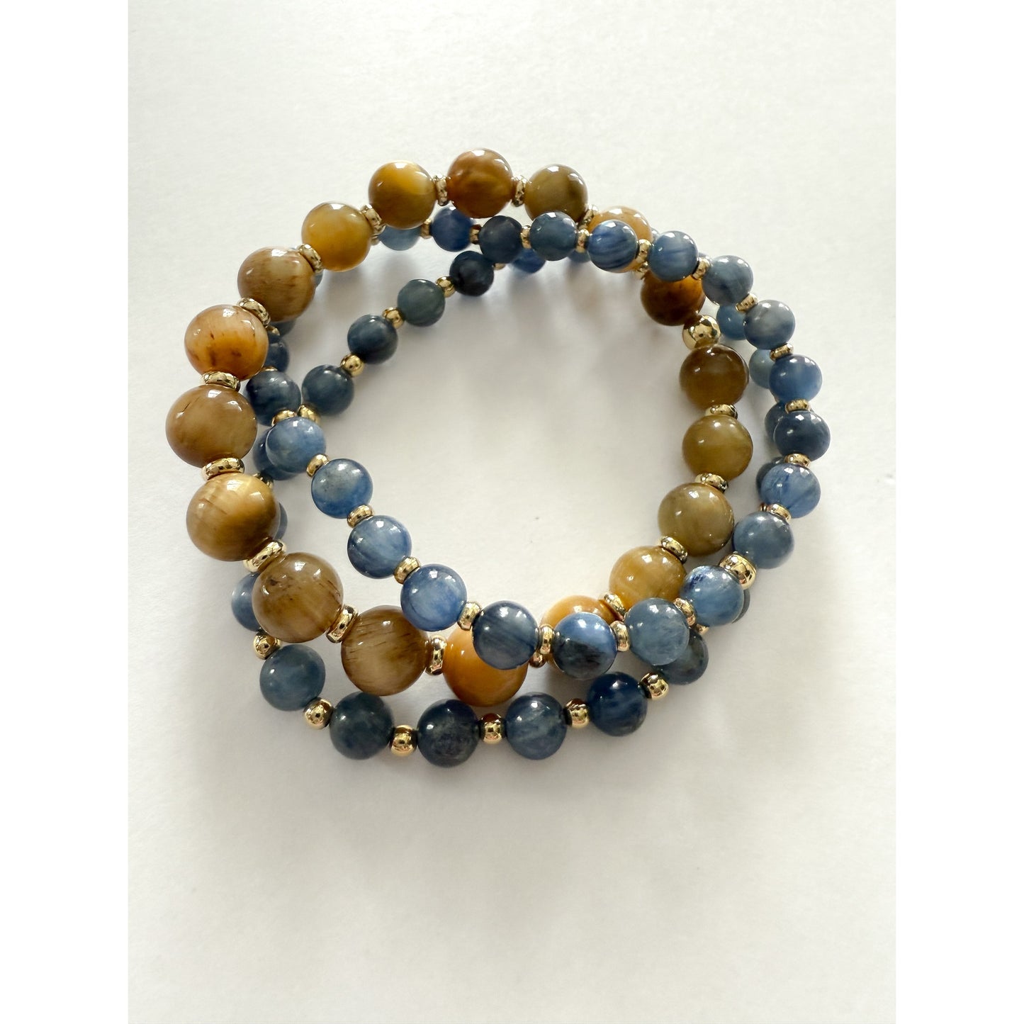 Blue kyanite and tigers eye stretch bracelet set with gold filled beads by HOPE & RAYE.