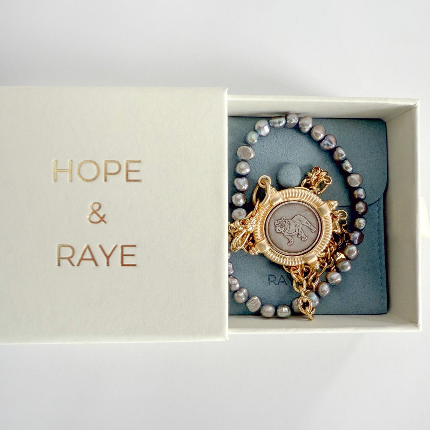 Gift ready packaging with Hope and Raye jewelry box and velvet pouch -Dainty bulldog charm – bulldog pendant necklace – gold filled paper clip chain and natural freshwater pearl adjustable medallion necklace – handcrafted by Hope and Raye.