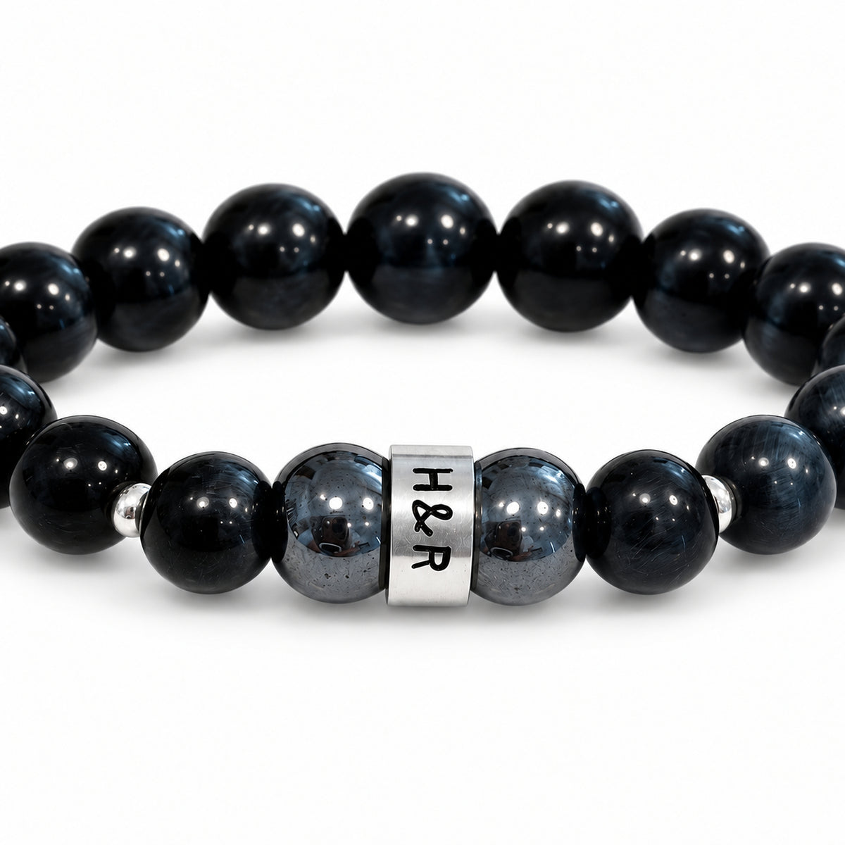 Men’s hematite and Falcon’s Eye stretch bracelet in blue-black tones with sterling silver connector.