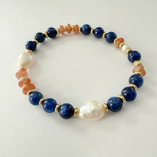 Orange blue and white stretch bracelet handcrafted with lapis, sandstone, freshwater baroque pearl and gold-filled beads.