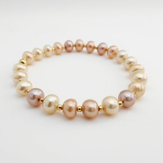 Genuine pink pearl with gold beaded stretch bracelet. Handcrafted in Atlanta by HOPE & RAYE.