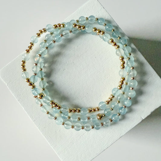 Dainty aquamarine and gold beaded bracelet stack by Hope and Raye
