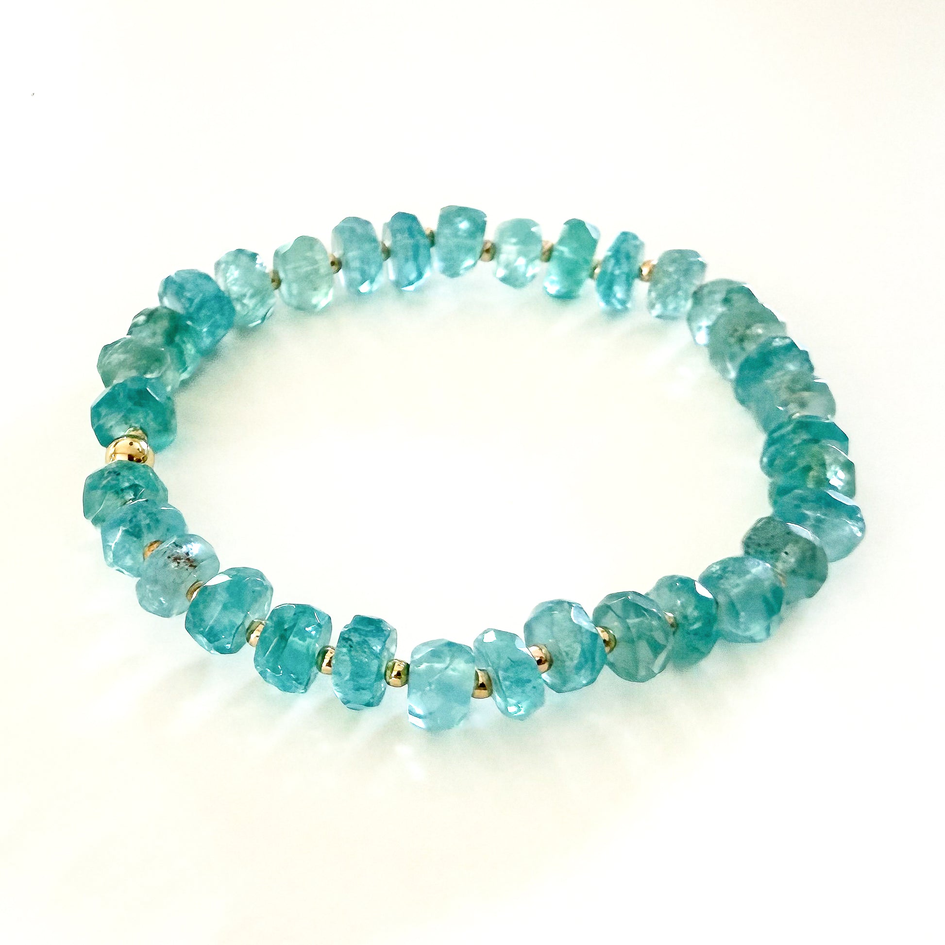 Blue apatite natural blue  gemstone beaded stretch bracelet with gold beads. Handcrafted by HOPE & RAYE in Atlanta. 