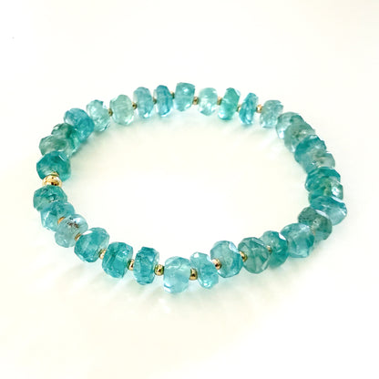 Blue apatite natural blue  gemstone beaded stretch bracelet with gold beads. Handcrafted by HOPE & RAYE in Atlanta. 