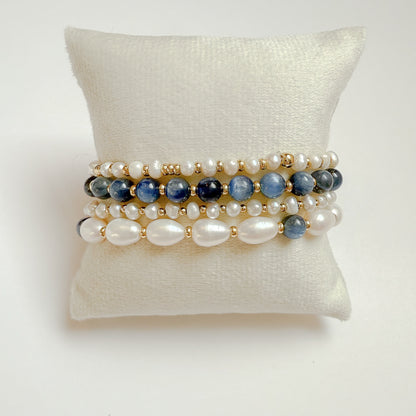 Bracelet stack of 4 bracelets: includes natural blue semi precious gemstones with natural smooth and baroque pearls and gold beads. All bracelets are easy on and easy off. Handcrafted on durable stretch cord. Includes 4 dainty stretch bracelets for daily wear. 