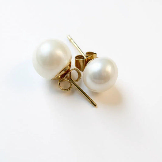 White natural 8 mm pearl earrings on gold post handmade to order. Nationwide shipping anywhere in USA And ships in jewelry box with velvet pouch for gifting.