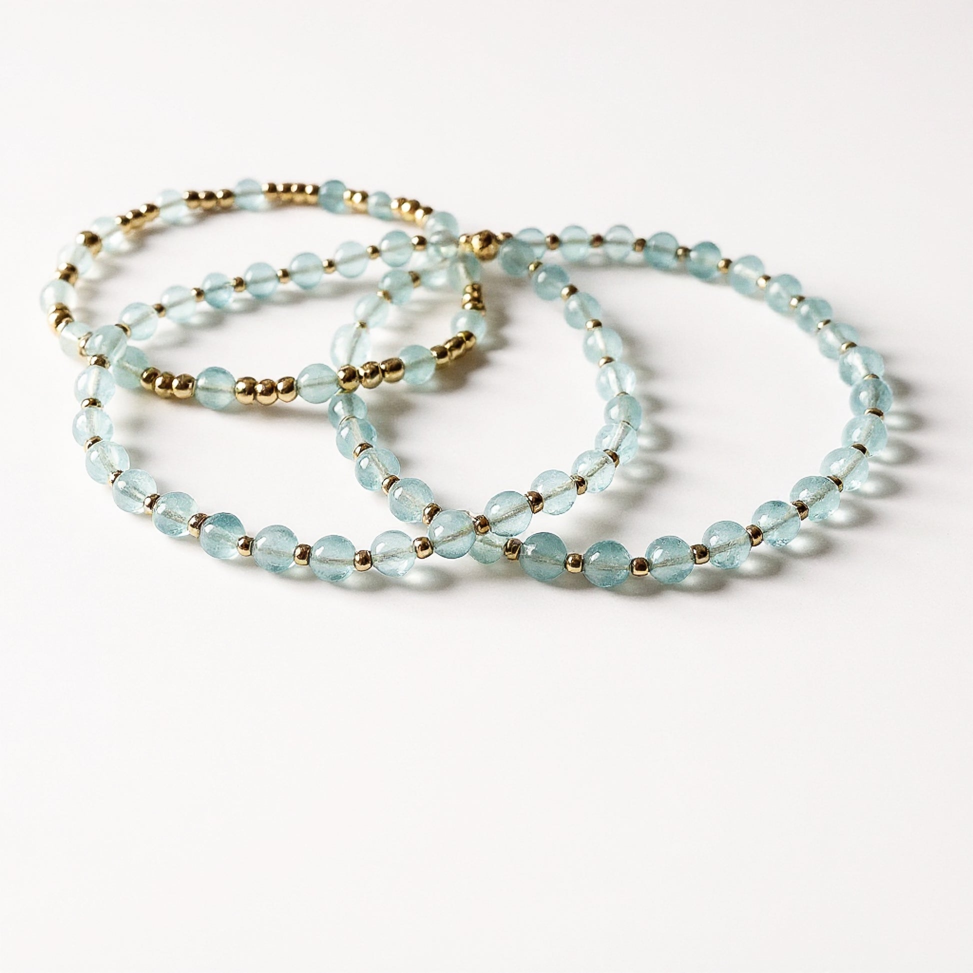Dainty aquamarine and gold bracelet set. Natural aquamarine and gold filled everyday bracelet trio stack.