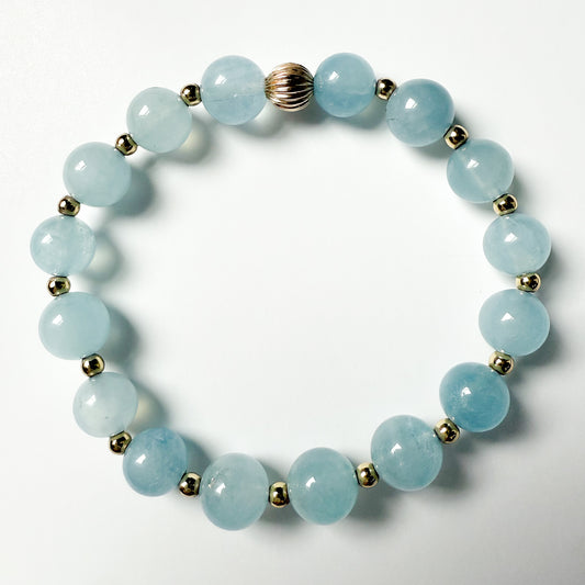 Aquamarine 7 mm beaded stretch bracelet with gold beads by Hope and Raye