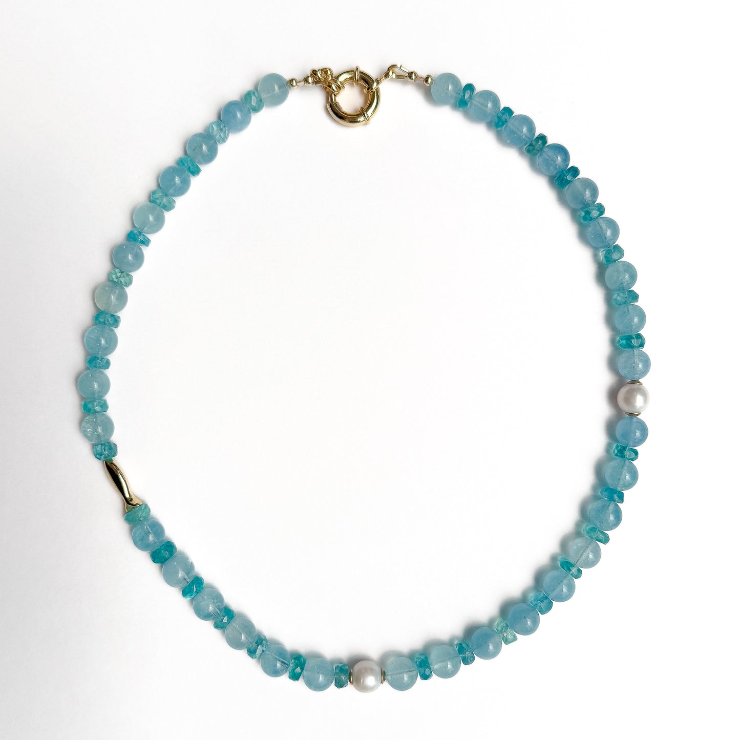 Natural aquamarine 16 1/2 inch beaded necklace with gold fish accent charm and gold spring clasp. Handcrafted in Atlanta by Hope and Raye. 