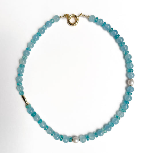 Natural aquamarine 16 1/2 inch beaded necklace with gold fish accent charm and gold spring clasp. Handcrafted in Atlanta by Hope and Raye. 