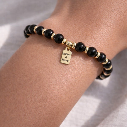 Black beaded oxide gemstone bracelet with gold discs. Layering bracelet for every day wear. Handcrafted with natural gemstones and 18k gold beads in Atlanta. 