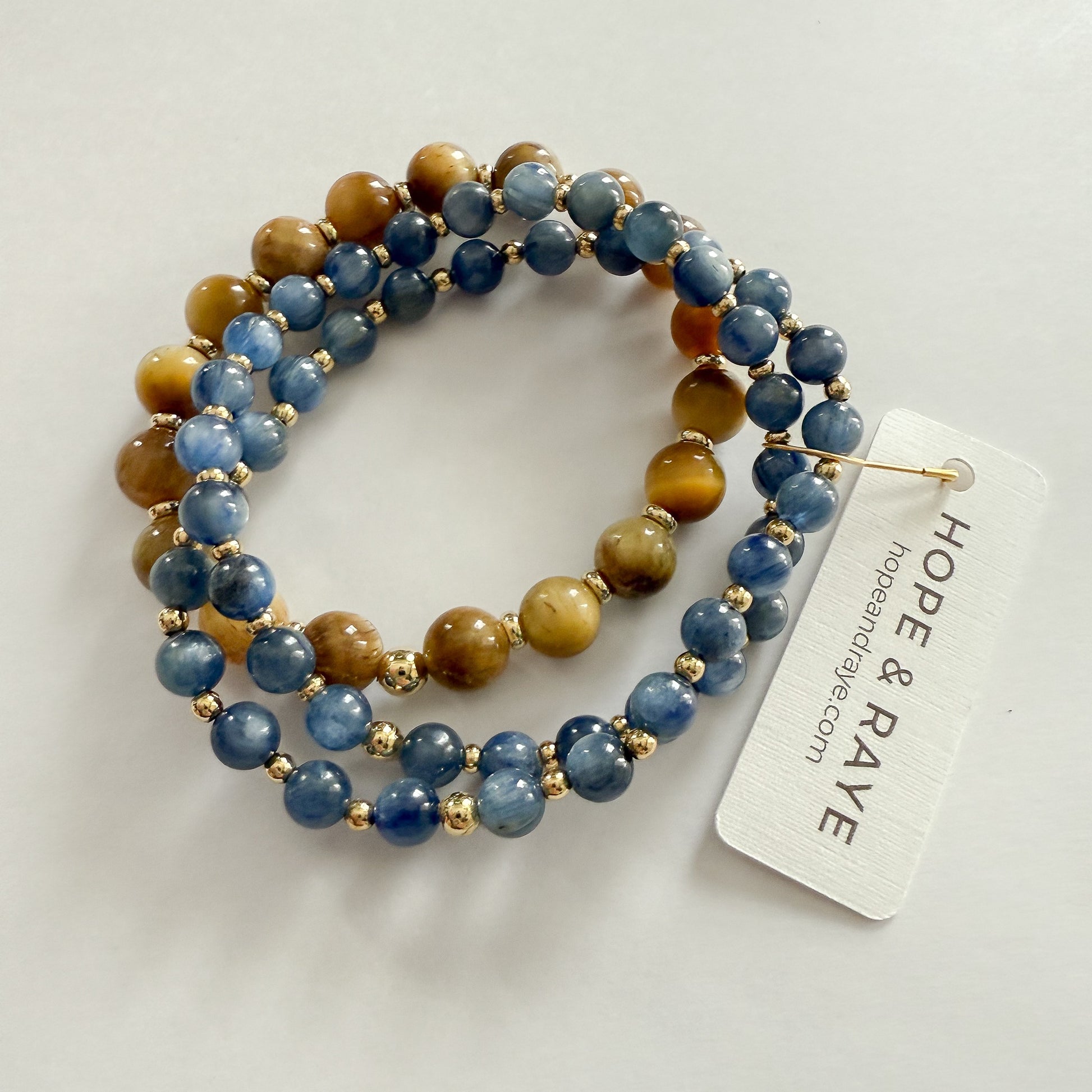 Blue natural gemstone beaded bracelet stack with Tiger's Eye and gold-filled beads on stretch material. Handcrafted by HOPE & RAYE in Atlanta, GA.