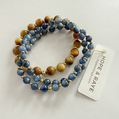 Blue natural gemstone beaded bracelet stack with Tiger's Eye and gold-filled beads on stretch material. Handcrafted by HOPE & RAYE in Atlanta, GA.