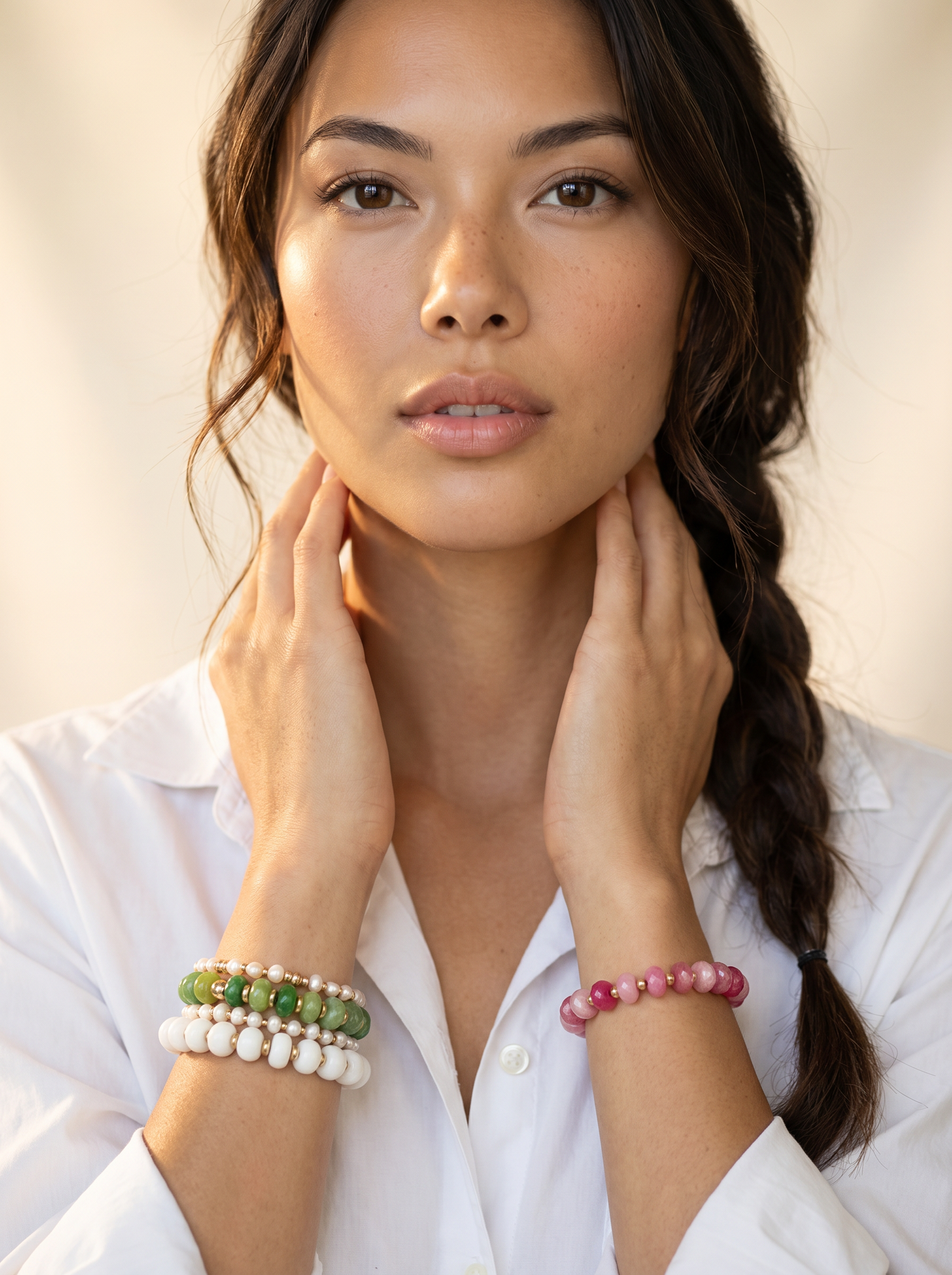 woman wearing HOPE & RAYE handmade beaded colorful bracelets on both wrist. Styled for summer fashion.