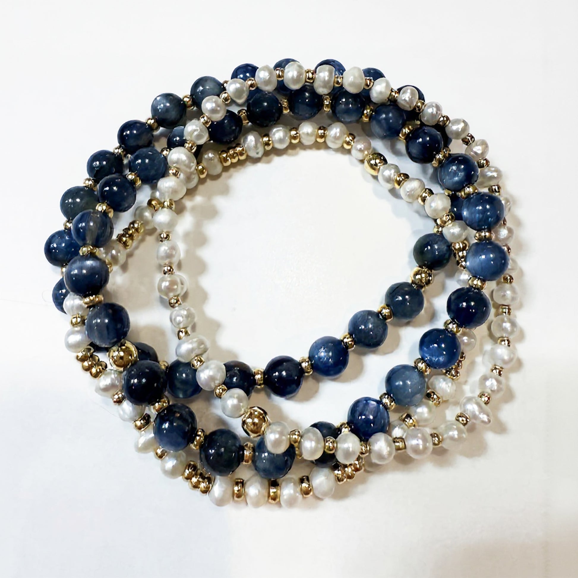 Kyanite gemstone bracelet stack with freshwater pearls by Hope and Raye. Stack of 4 bracelets.