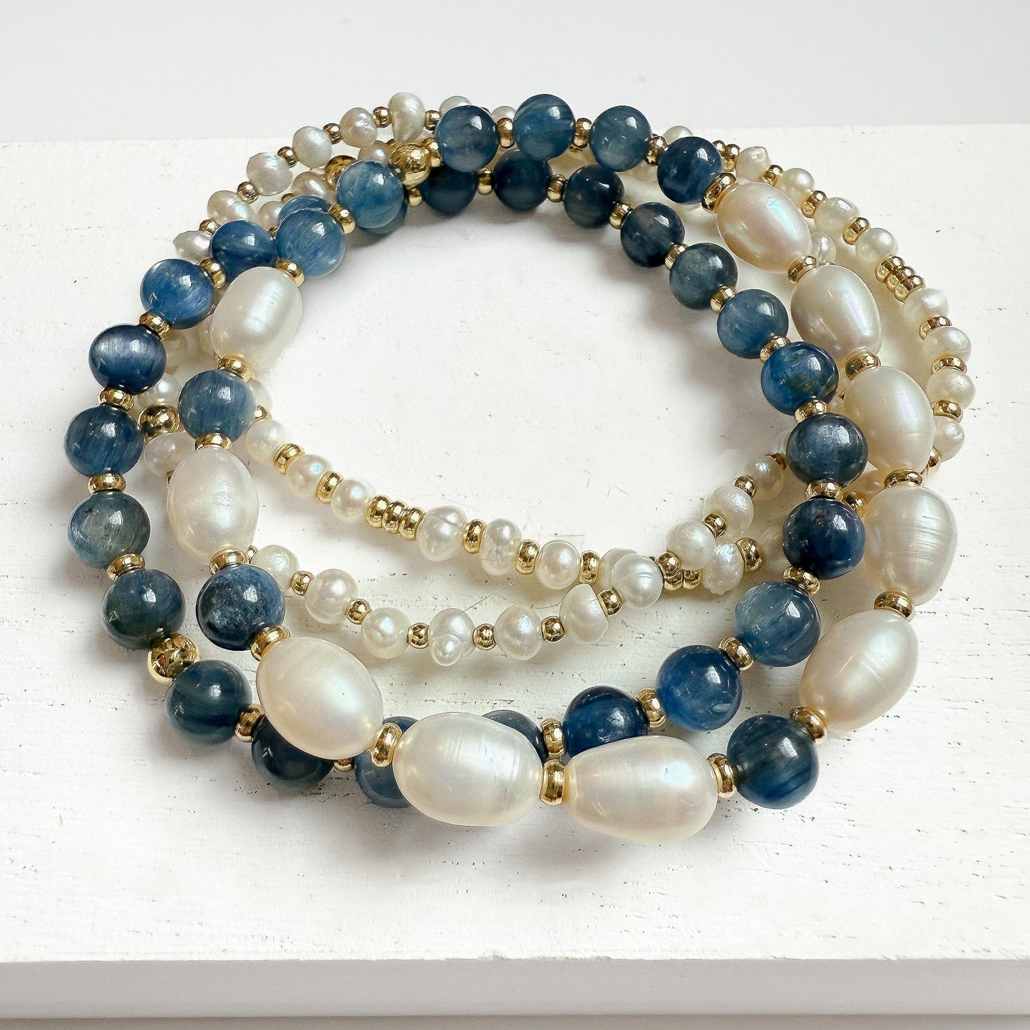 Smooth oval freshwater pearls, kyanite, and dainty baroque pearl bracelet stack of 4. Curated bracelet stack handcrafted in atlanta by HOPE & RAYE. 