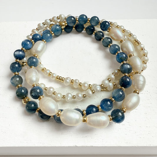 Smooth oval freshwater pearls, kyanite, and dainty baroque pearl bracelet stack of 4. Curated bracelet stack handcrafted in atlanta by HOPE & RAYE. 