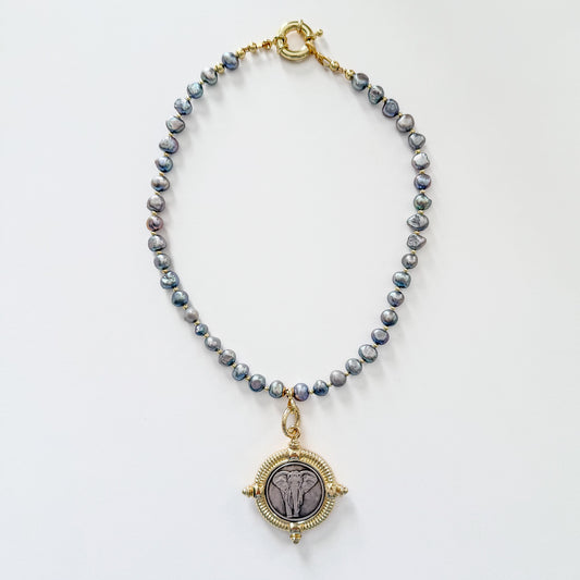 Pearl necklace with elephant pendant and gold spring clasp by Hope and Raye.