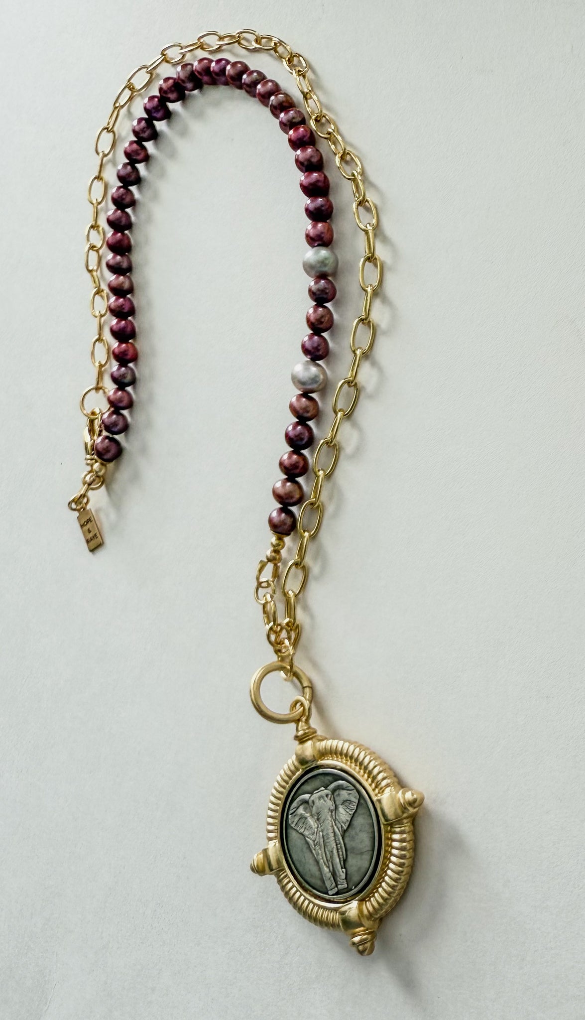 Gold chain necklace with elephant pendant and crimson pearls handcrafted by Hope and Raye. Roll tide elephant necklace.