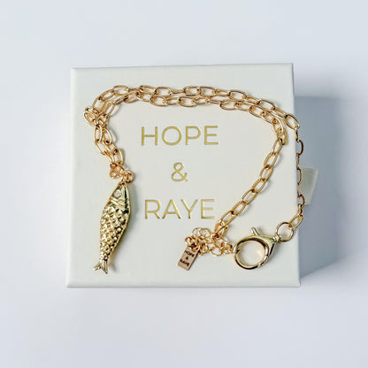 Minimalist gold charm necklace with Fish charm by Hope and Raye. Ships gift-ready in branded pull-out jewelry box and velvet pouch for safe keeping. 