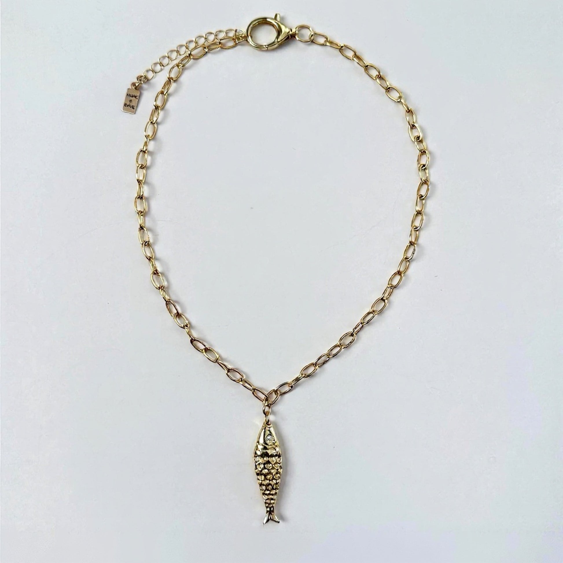 Fish charm on gold dainty adjustable chain with large lobster claw gold- filled clasp by Hope and Raye. 