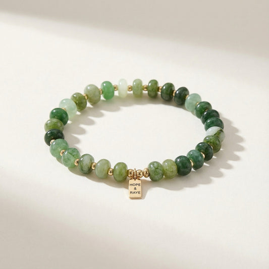 Jade green quartz stretch bracelet with smooth rondelle natural stone beads and 18K gold-filled details featuring a HOPE & RAYE brand tag.