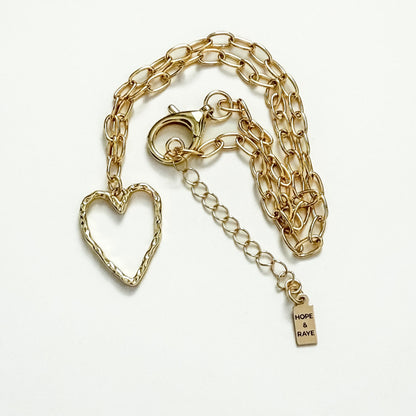 Hammered gold heart charm necklace handcrafted by Hope & Raye