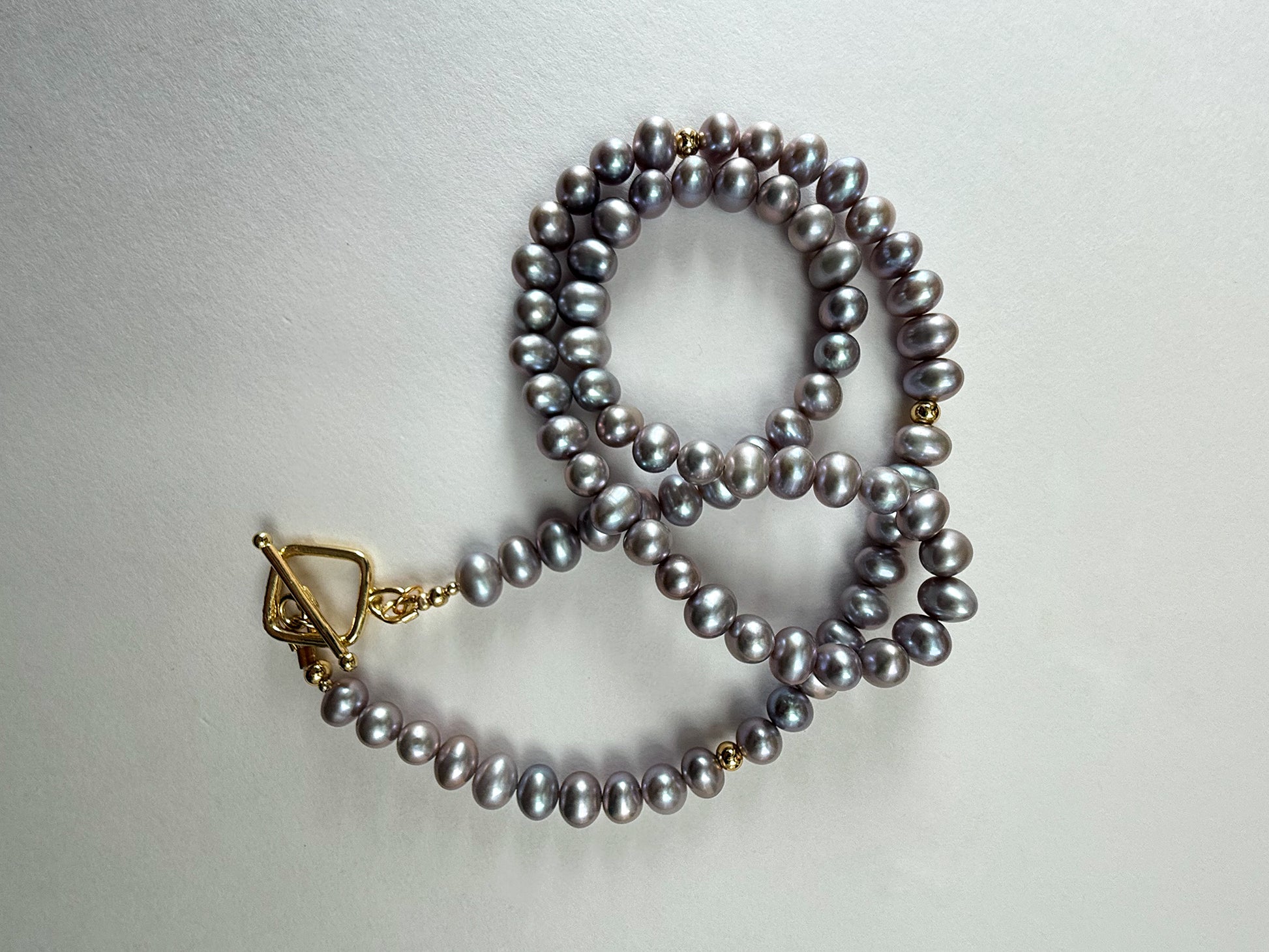 Peacock freshwater pearl necklace styled in loop with gold clasp – handmade 18-inch necklace by Hope & Raye