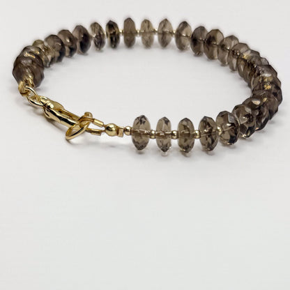 Smoky quartz bracelet with gold beads and gold clasp. Handcrafted in Atlanta by Hope and Raye.