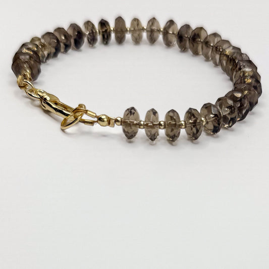 Smoky quartz bracelet with gold beads and gold clasp. Handcrafted in Atlanta by Hope and Raye.