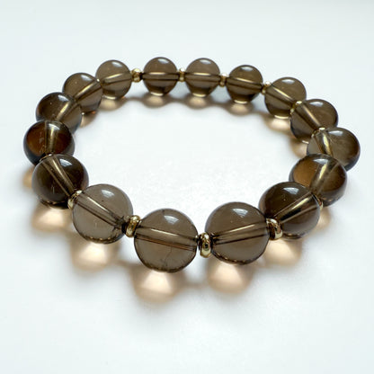 Natural brown smoky quartz smooth round beaded bracelet with 18k gold filled discs. Handcrafted in Atlanta GA.