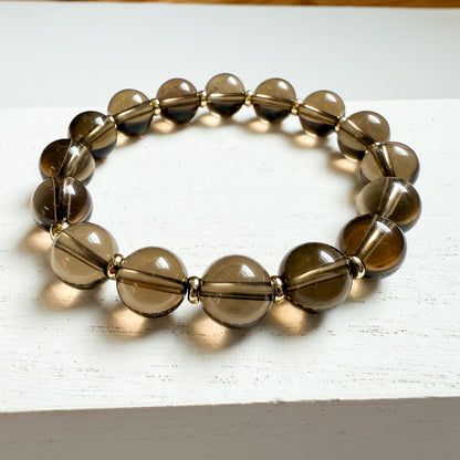 Classic smoky quartz 10mm beaded bracelet with gold filled discs. Stretch material for easy everyday wear and stacking with other favorite bracelets. 