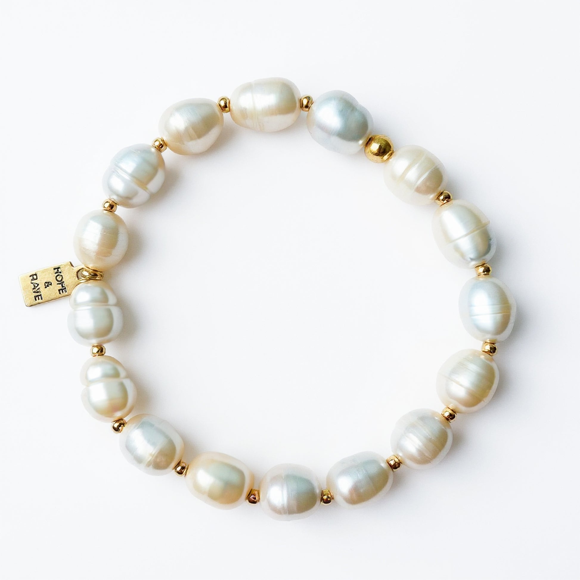 Baroque white pearl stretch layering bracelet with gold discs by Hope and Raye. 
