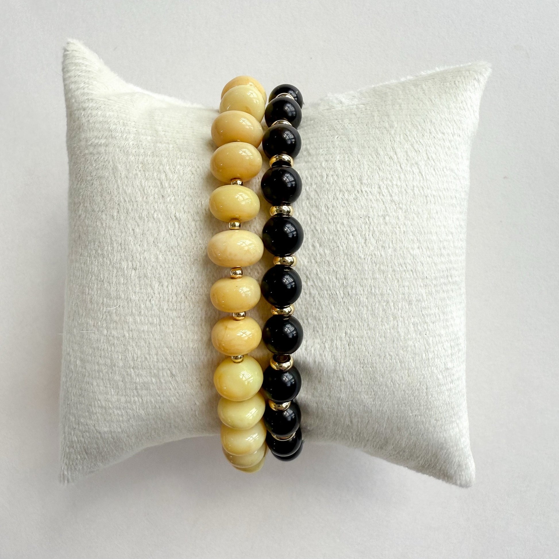 Natural yellow opal stretch bracelet paired with a black fox Falcons eye and gold bracelet set of 2. And crafted in Atlanta..