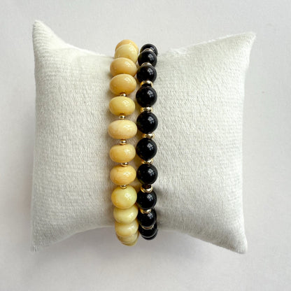 Natural yellow opal stretch bracelet paired with a black fox Falcons eye and gold bracelet set of 2. And crafted in Atlanta..
