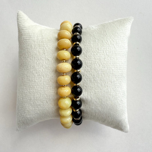 Natural yellow opal stretch bracelet paired with a black fox Falcons eye and gold bracelet set of 2. And crafted in Atlanta..